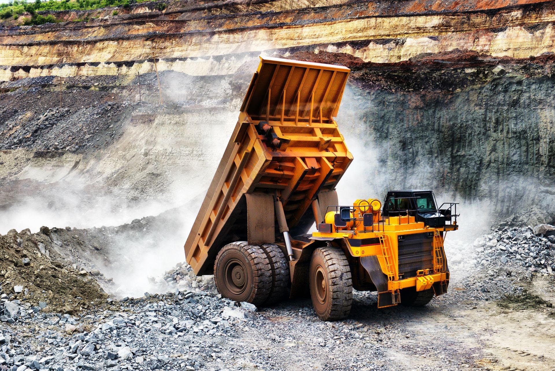 large mining loader unloads extracted ore or rock. View from the back. Mining concept